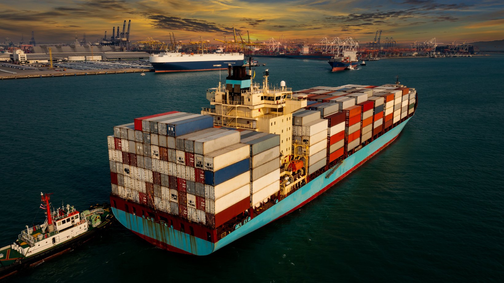 ship container transporting large cargo logistic import export goods internationally worldwide and shipping port background industry business service transportation by container ship in sea at evening angle view